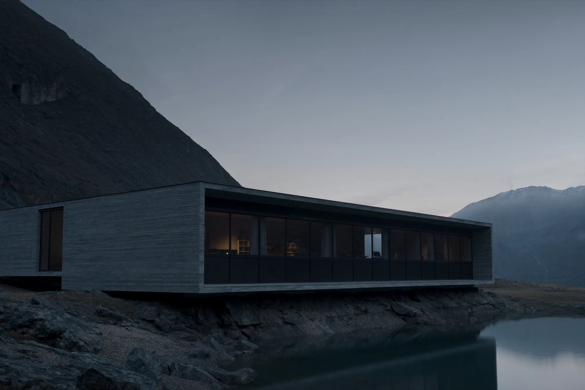 Residencia contemporánea entre una montaña y un lago